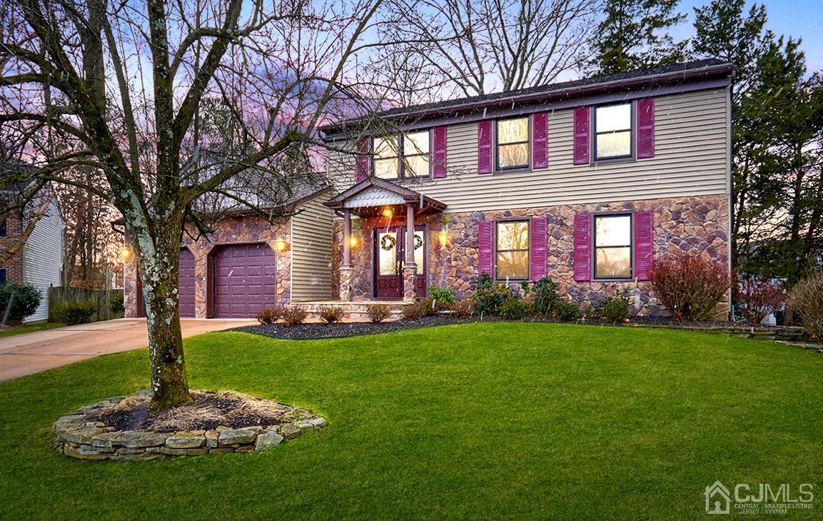 a front view of a house with a garden