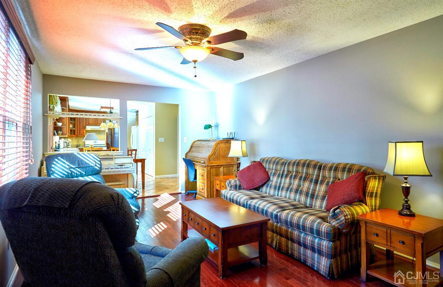 21 Aqueduct Place Howell, NJ 07731 - Photo 13 of 44 a living room with furniture and a lamp