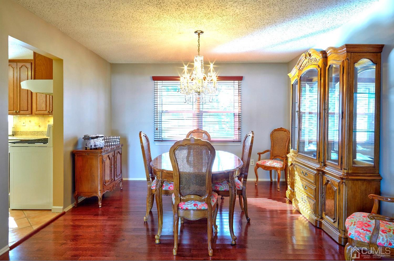 21 Aqueduct Place Howell, NJ 07731 - Photo 16 of 44 a view of a dining room with furniture window and wooden floor