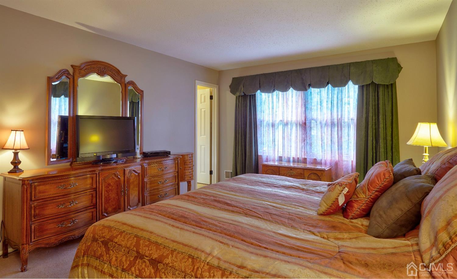 21 Aqueduct Place Howell, NJ 07731 - Photo 20 of 44 a bedroom with a bed and a flat screen tv