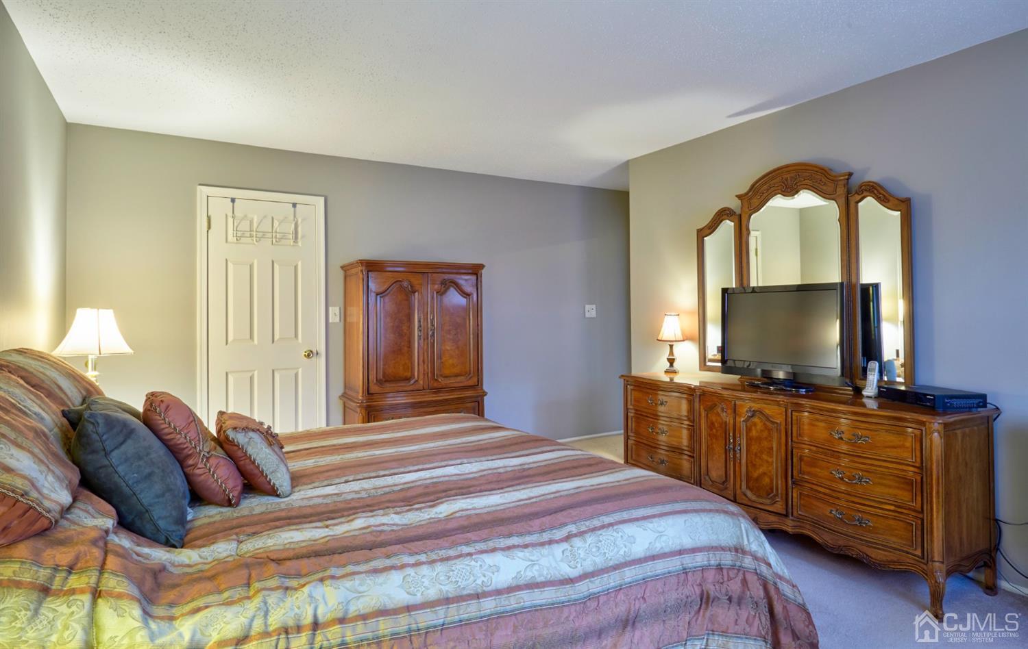 21 Aqueduct Place Howell, NJ 07731 - Photo 34 of 44 a bedroom with a balcony a bed and a flat screen television