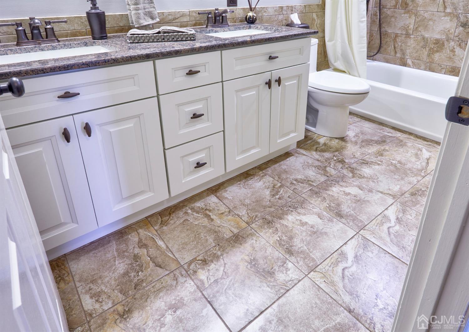 21 Aqueduct Place Howell, NJ 07731 - Photo 39 of 44 a bathroom with a granite countertop sink a toilet and a bathtub