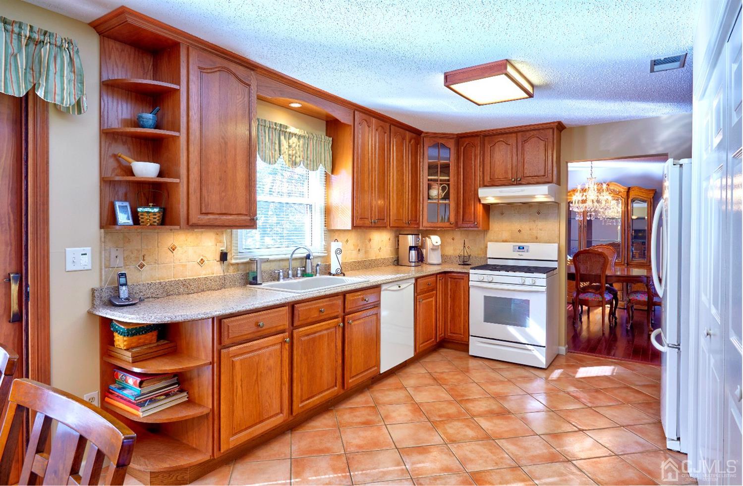 21 Aqueduct Place Howell, NJ 07731 - Photo 6 of 44 a kitchen with stainless steel appliances a sink and a refrigerator