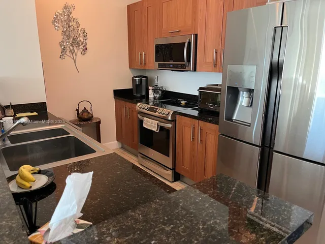 a kitchen with a refrigerator stove and microwave