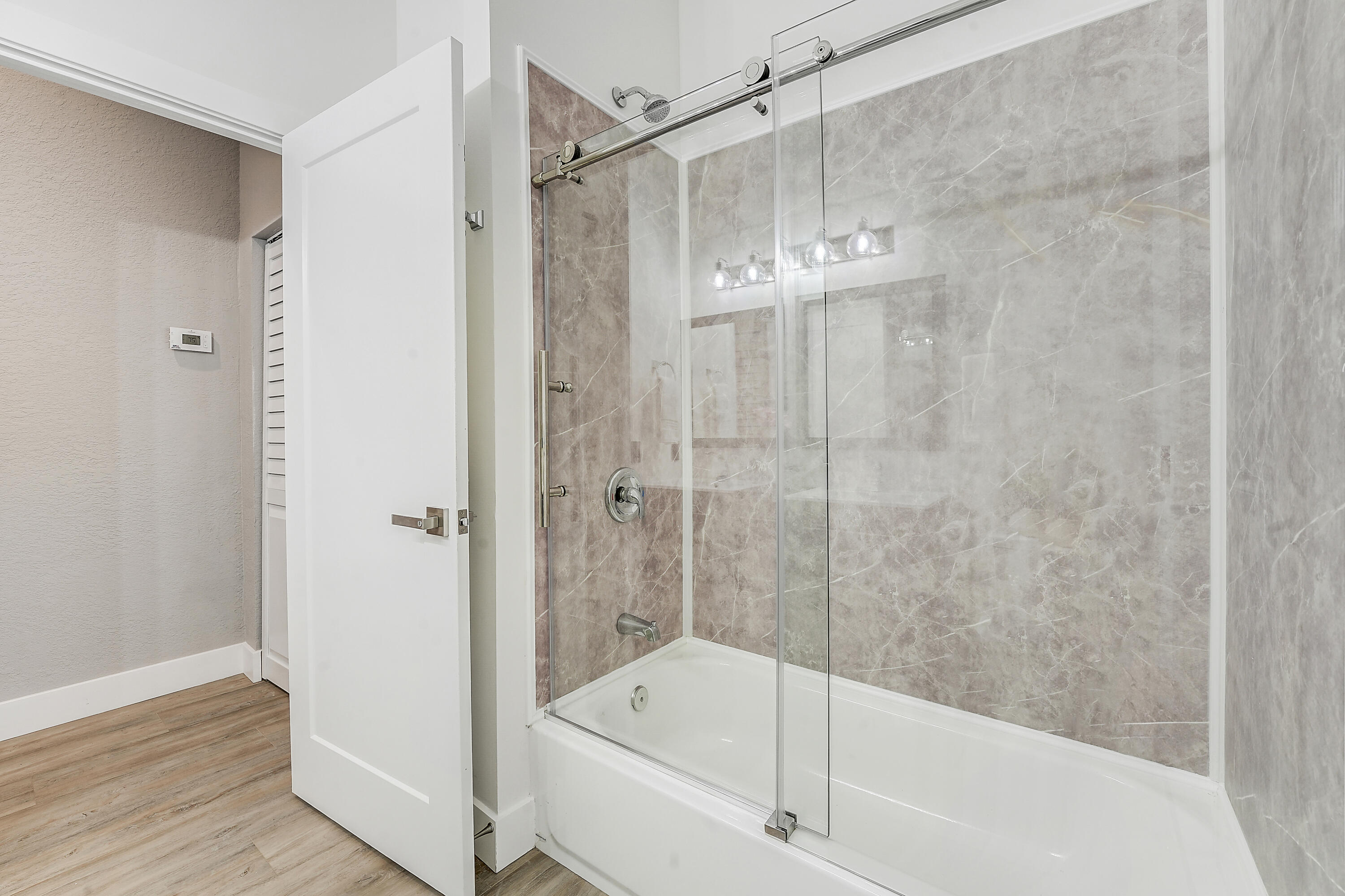 127 Via Castilla Jupiter, FL 33458 - Photo 30 of 80 a bathroom with a bathtub and a shower