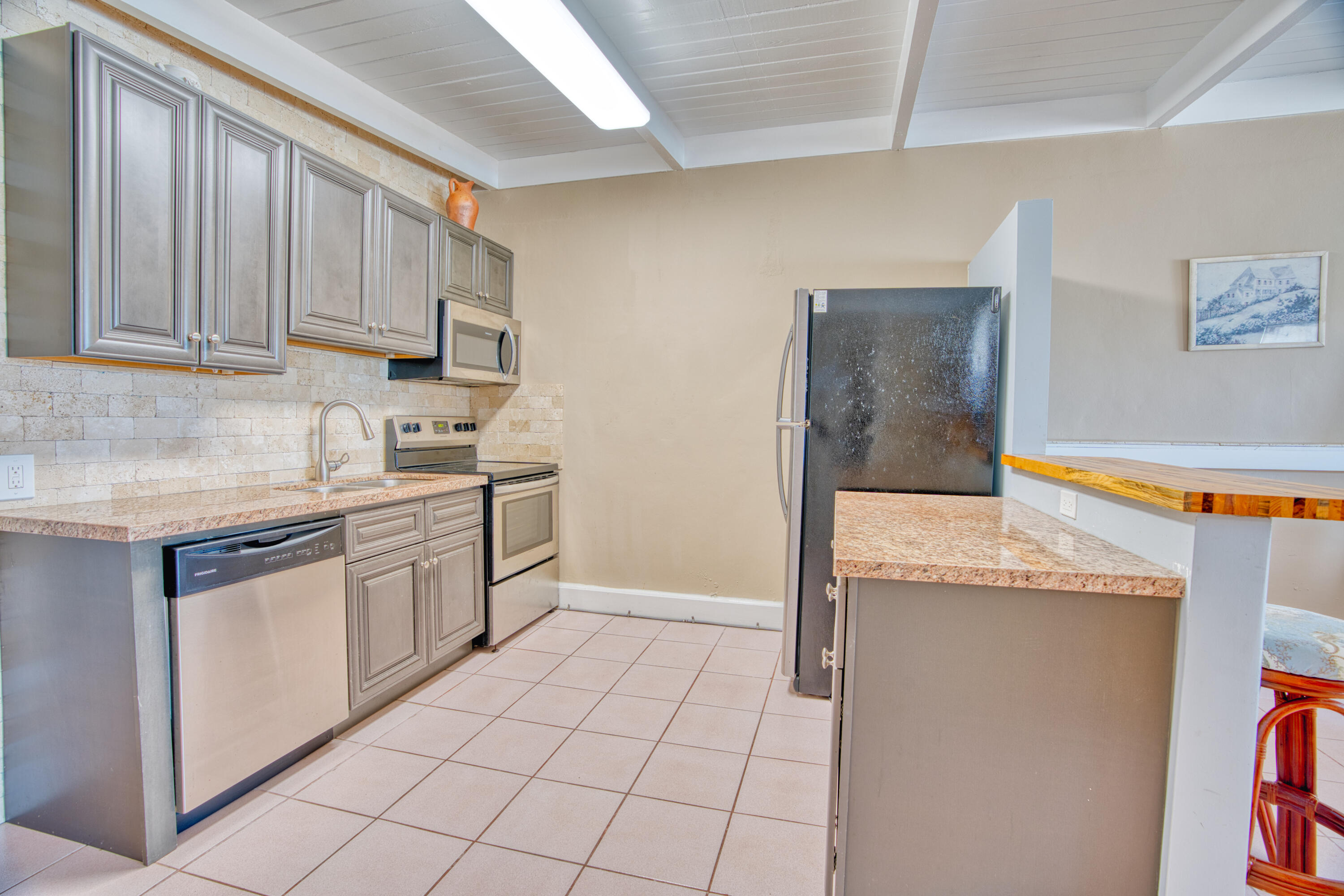 5 Sadowski Key Key Colony Beach, FL 33051 - Photo 16 of 26 a kitchen with stainless steel appliances granite countertop a stove a sink and a refrigerator