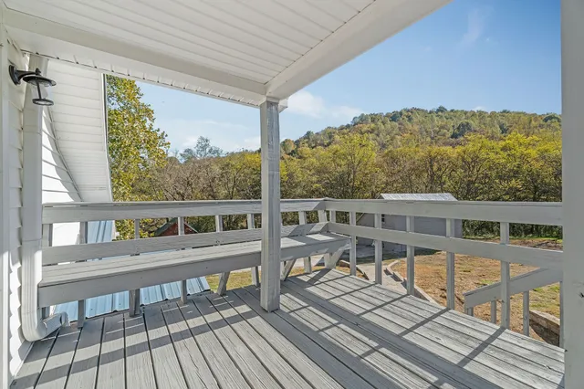 a view of a balcony with wooden floor and city view