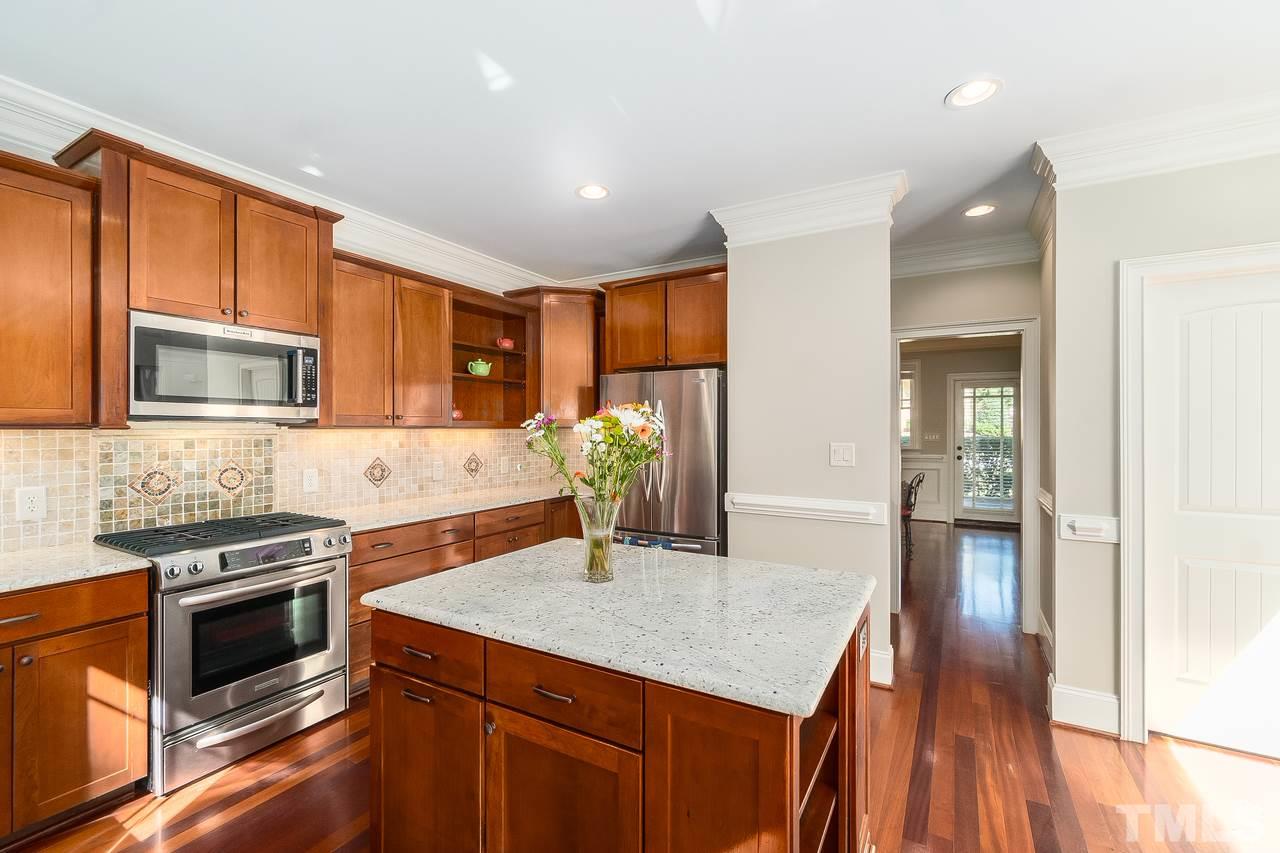 2310 Finley Ridge Lane Raleigh, NC 27615 - Photo 12 of 29 Granite Countertops, Large walk-in pantry and butlers pantry with glass doors.
