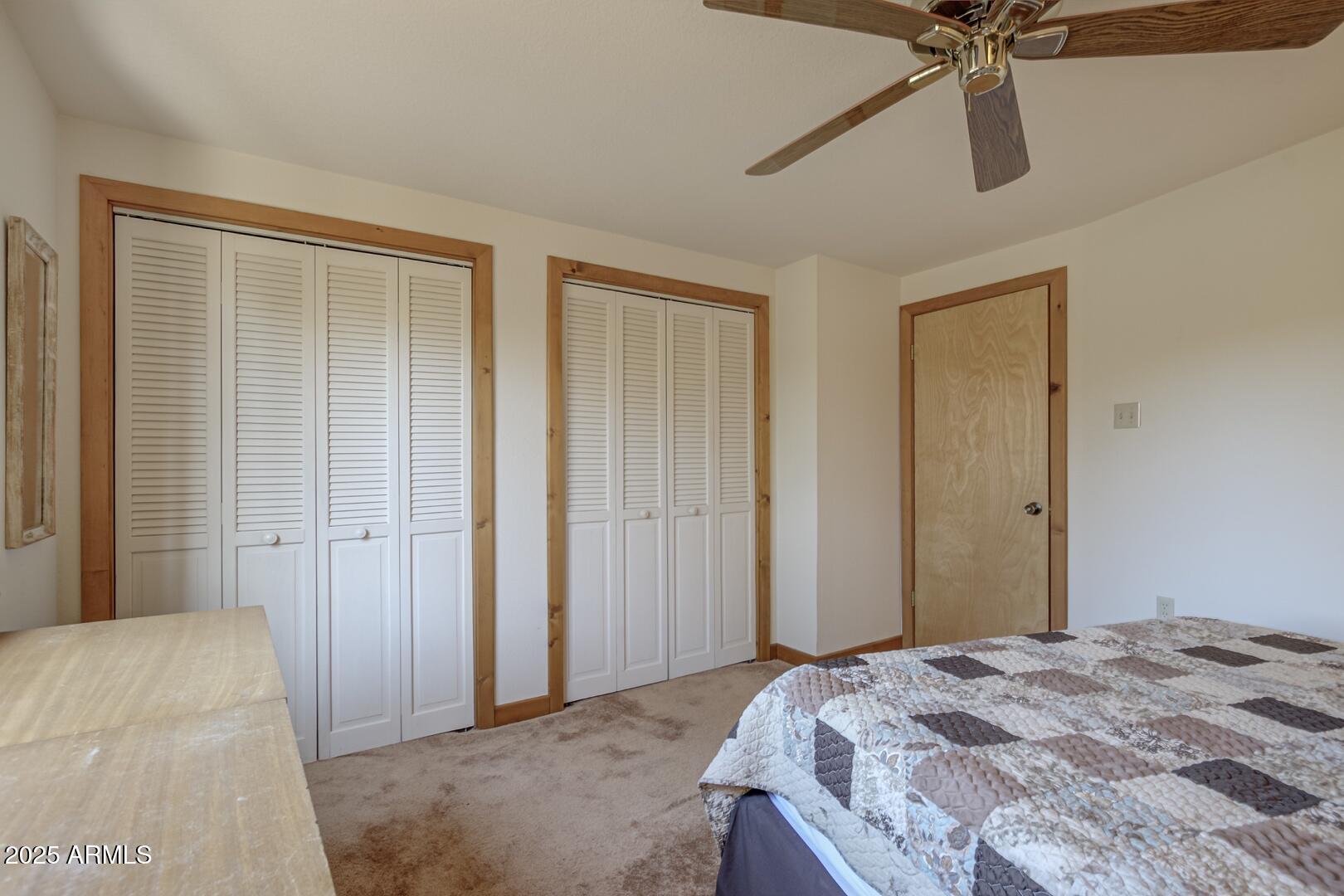 6181 Sharyn Road Pine, AZ 85544 - Photo 17 of 46 a bedroom with a bed and a chandelier
