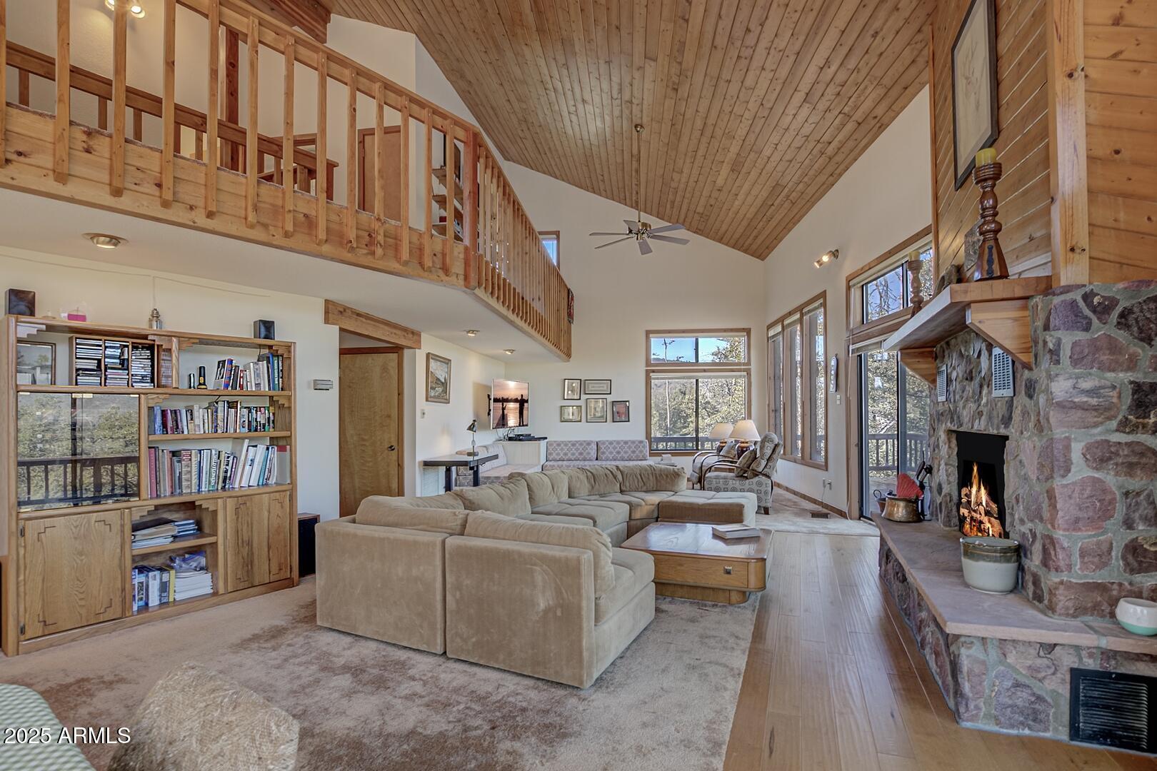 6181 Sharyn Road Pine, AZ 85544 - Photo 4 of 46 a living room with fireplace furniture and a book shelf