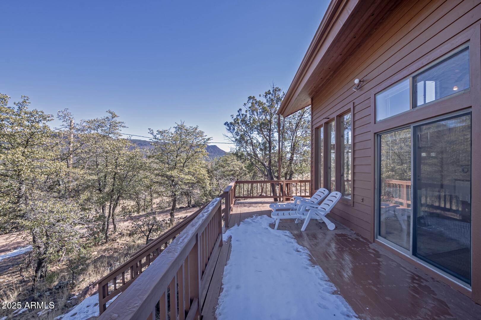 6181 Sharyn Road Pine, AZ 85544 - Photo 41 of 46 a balcony with table and chairs and wooden fence