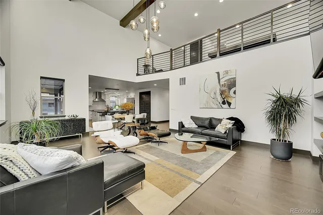 a living room with furniture potted plant and a kitchen