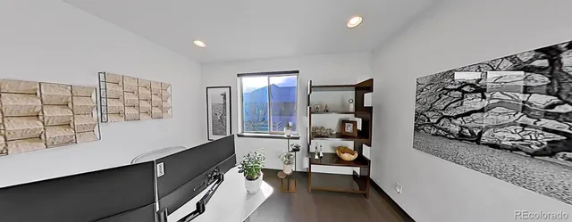 a hallway with a large window and couch