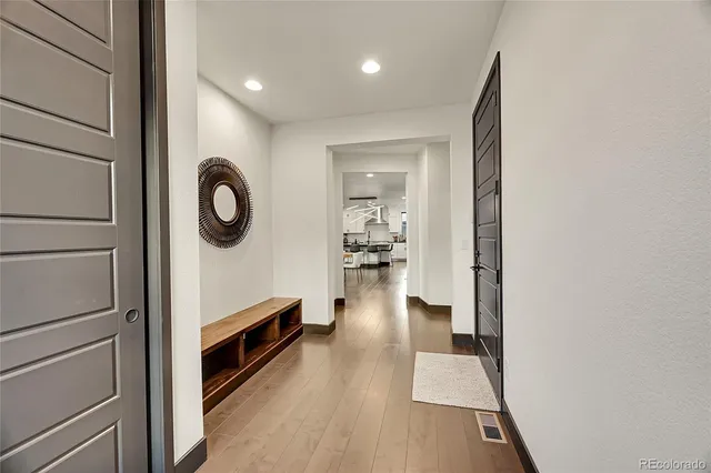 a view of living room and hallway with wooden floor
