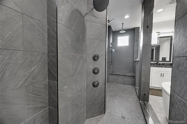 a bathroom with a shower and a sink