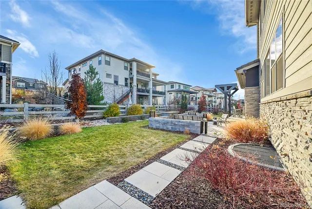 a view of a house with backyard and sitting area