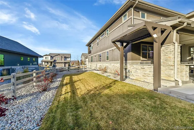 a room with lots of glass windows and furniture