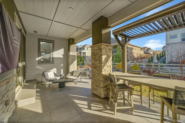 a view of a patio with chairs and potted plants