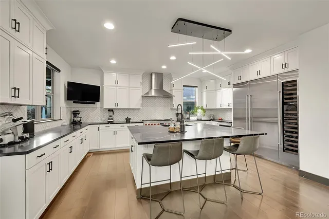 a kitchen with stainless steel appliances kitchen island granite countertop a sink and cabinets