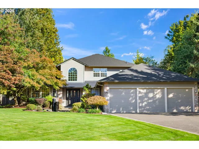 a front view of a house with a garden