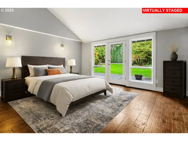 a bedroom with a bed and a large window