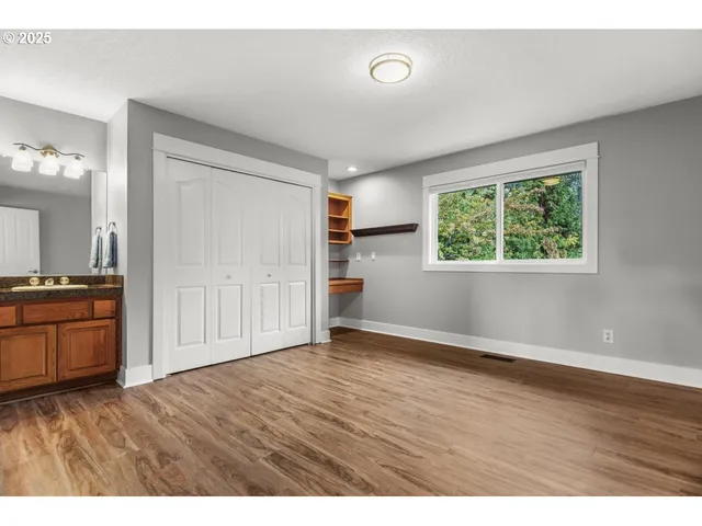 a view of an empty room with a kitchen