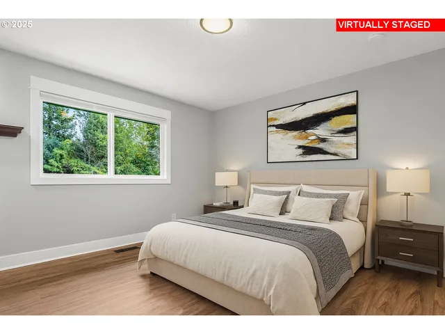 a bedroom with a bed and a painting on the wall