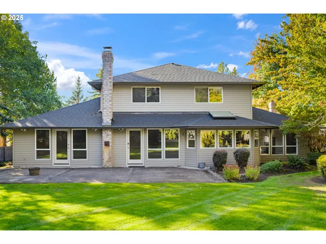 a front view of a house with a yard table and chairs