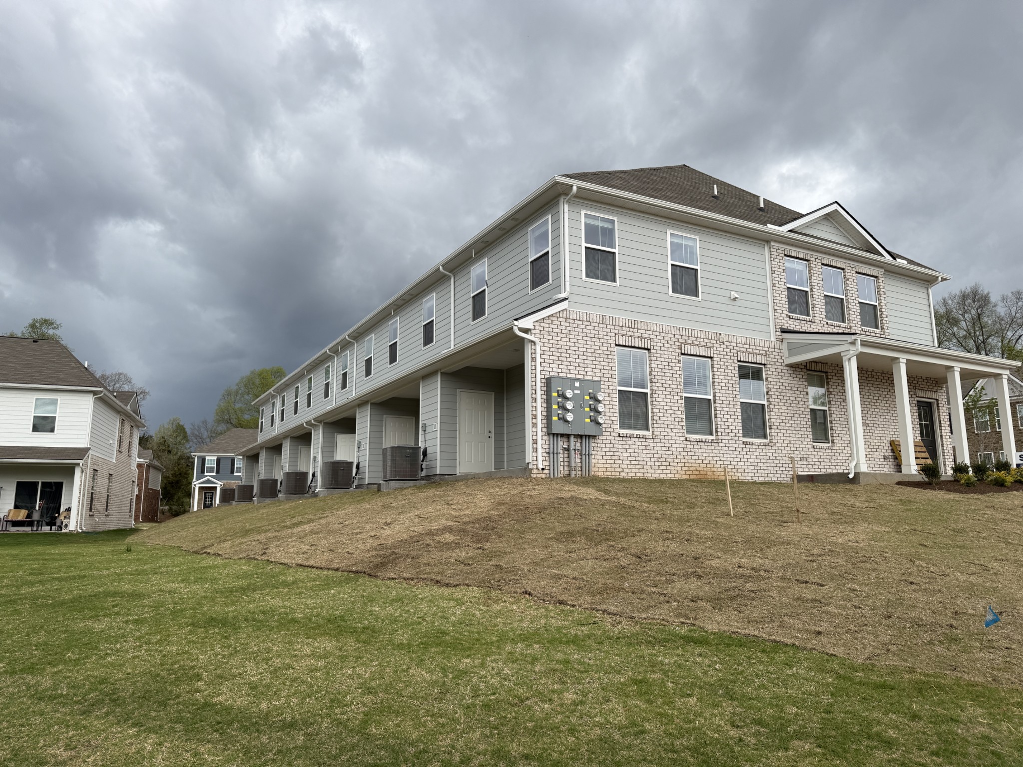 907 Highfield Way Lebanon, TN 37087 - Photo 10 of 10 a large white building with a big yard and large trees