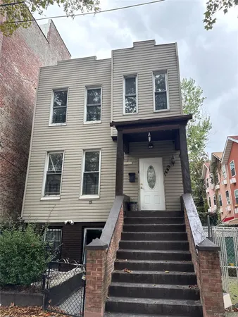 a front view of a house with stairs