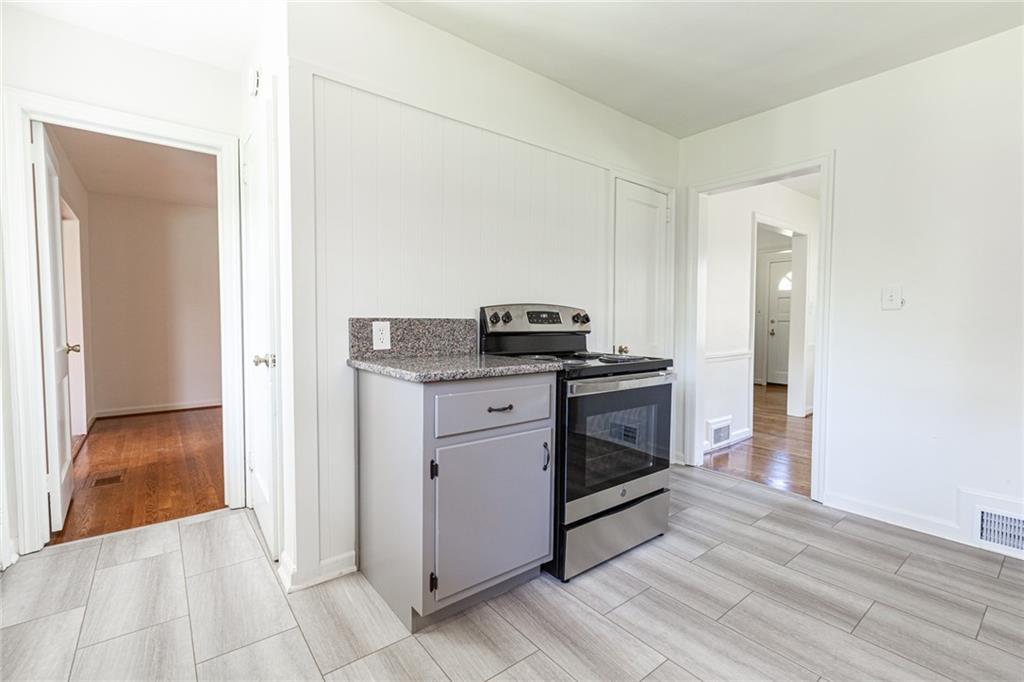 2115 Pinellas Trail Decatur, GA 30033 - Photo 13 of 29 a kitchen with granite countertop a sink and a stove top oven
