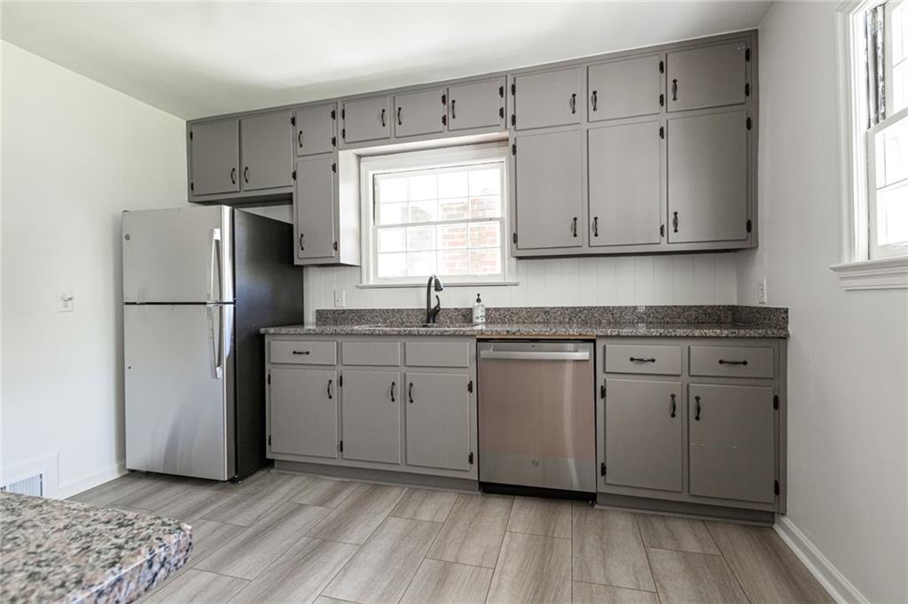 2115 Pinellas Trail Decatur, GA 30033 - Photo 3 of 29 a kitchen with granite countertop cabinets appliances and a window