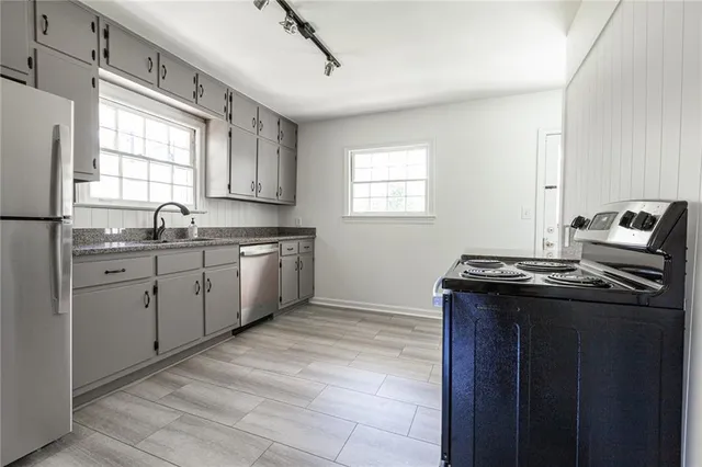 a kitchen with a sink stove and cabinets