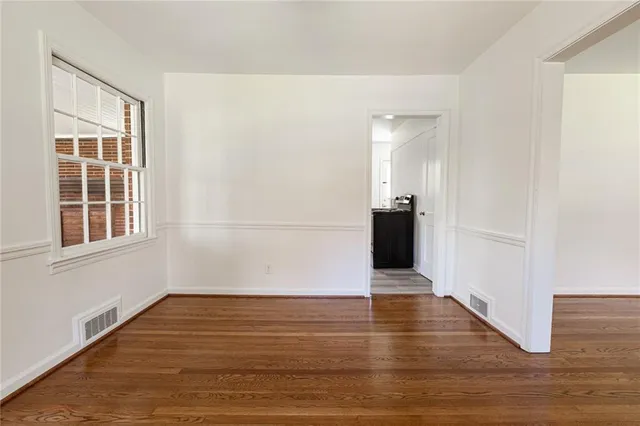 a view of a black and white wall with wooden floor