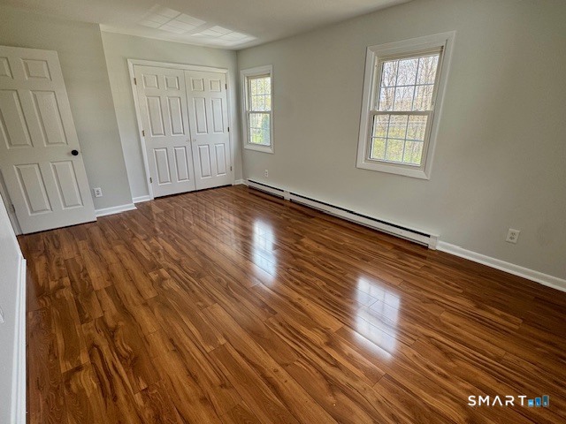 15 Juniper Road Bethel, CT 06801 - Photo 8 of 17 an empty room with wooden floor and windows