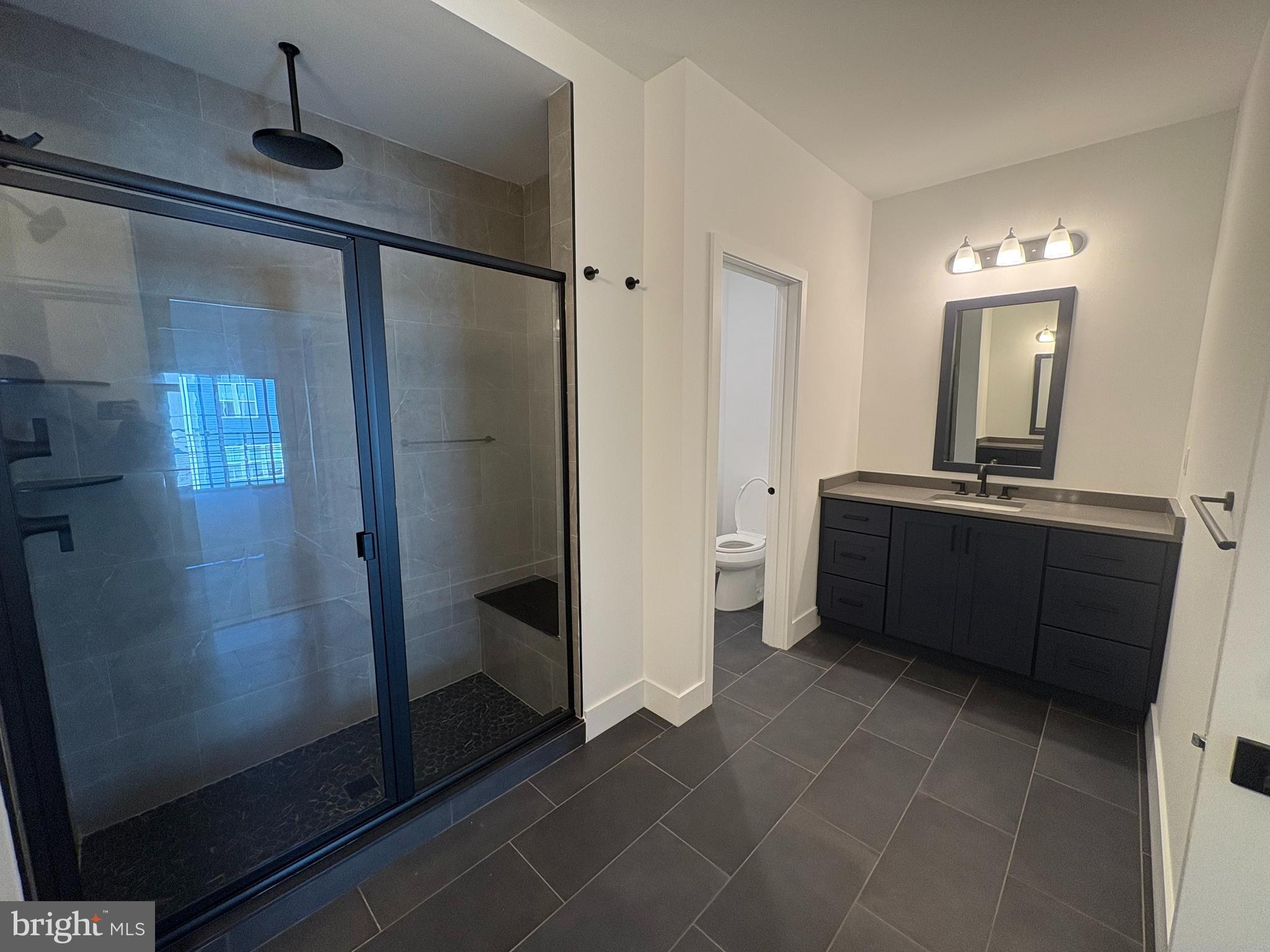 8207 Donatello Drive, Unit 872 Princeton, NJ 08540 - Photo 18 of 27 a bathroom with a sink a mirror and a shower