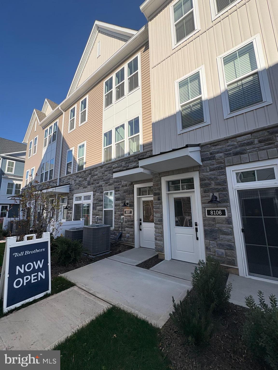 8207 Donatello Drive, Unit 872 Princeton, NJ 08540 - Photo 22 of 27 a front view of a house with yard and garage