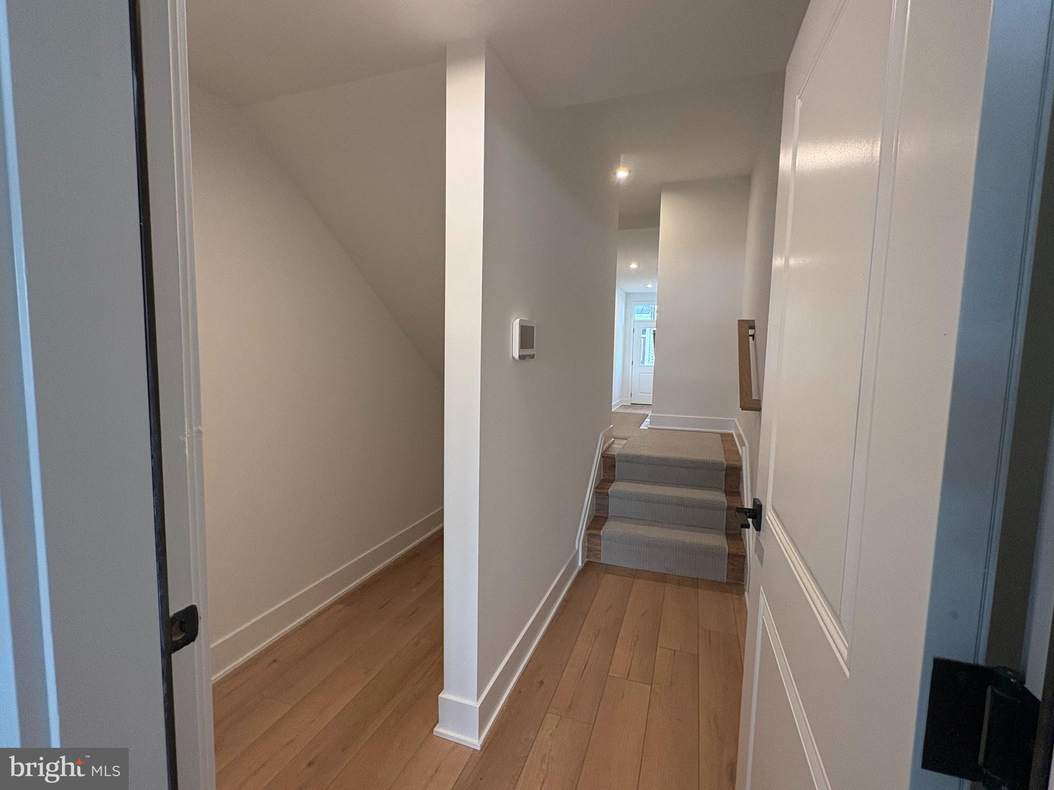 8207 Donatello Drive, Unit 872 Princeton, NJ 08540 - Photo 26 of 27 a view of a hallway with wooden floor and staircase