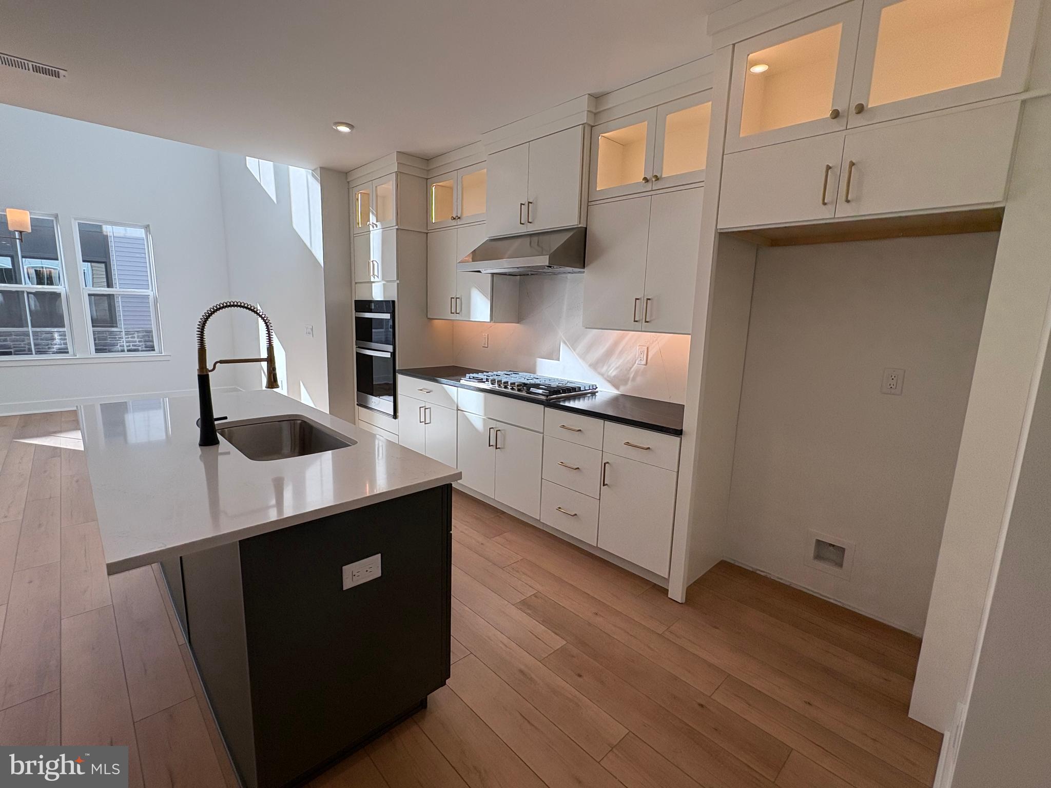 8207 Donatello Drive, Unit 872 Princeton, NJ 08540 - Photo 4 of 27 a kitchen with kitchen island granite countertop a sink a stove and cabinets
