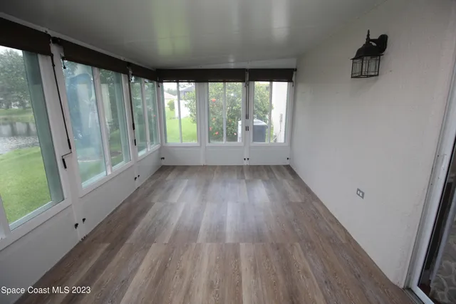 a view of wooden floor and windows in a room