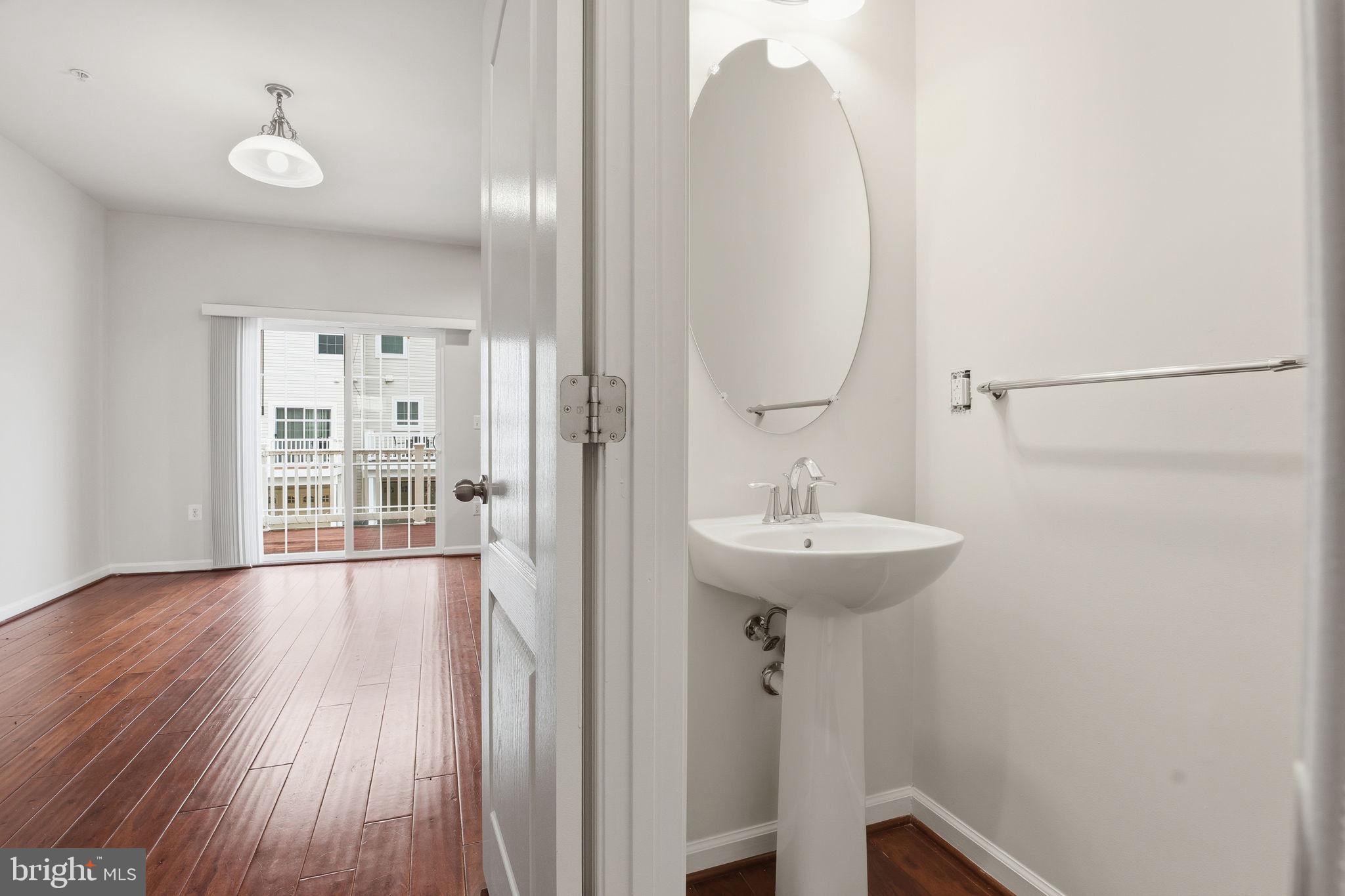 7025 Southmoor Street Hanover, MD 21076 - Photo 17 of 35 a bathroom with a sink a mirror and a toilet