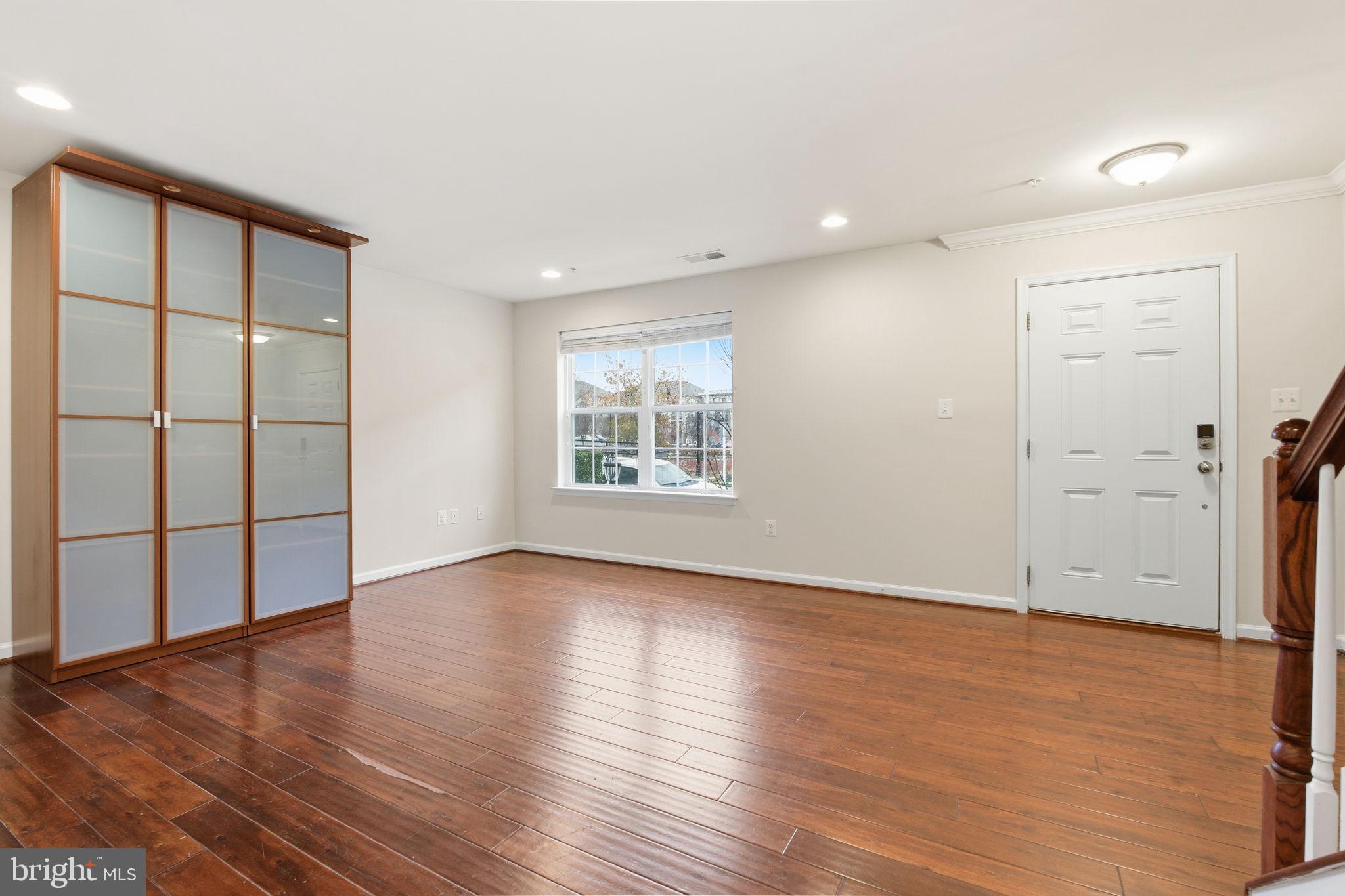 7025 Southmoor Street Hanover, MD 21076 - Photo 3 of 35 an empty room with wooden floor and windows