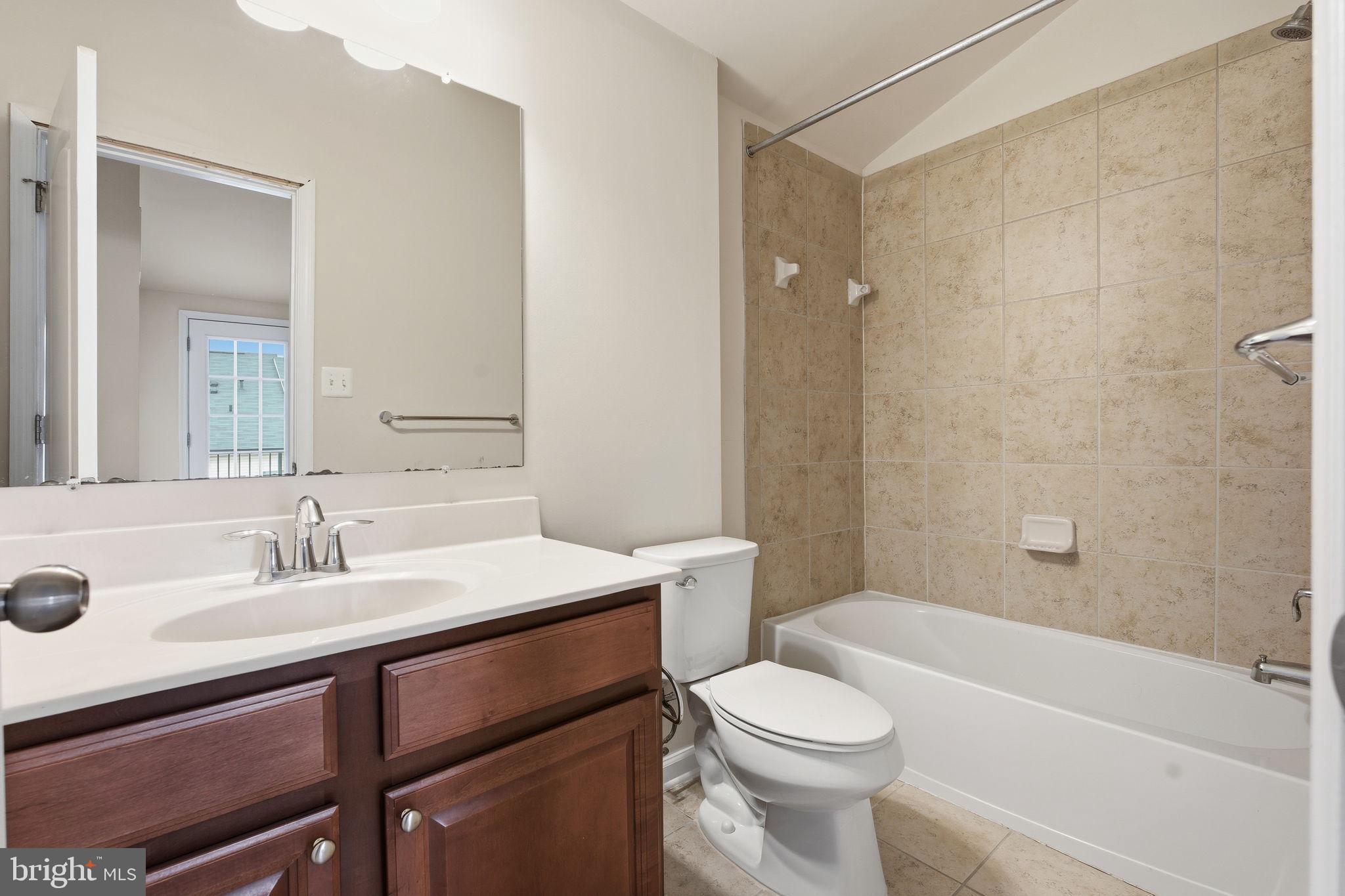 7025 Southmoor Street Hanover, MD 21076 - Photo 31 of 35 a bathroom with a sink a toilet and shower