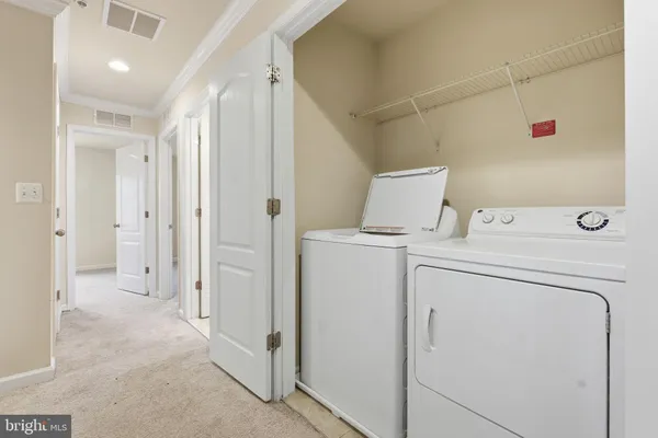 a view of storage and utility room with washer and dryer