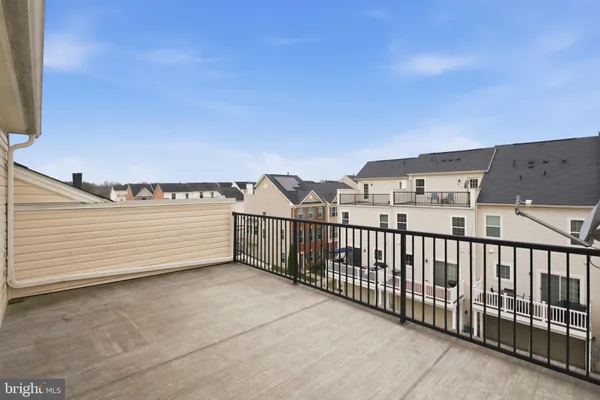 a view of a balcony with an outdoor seating