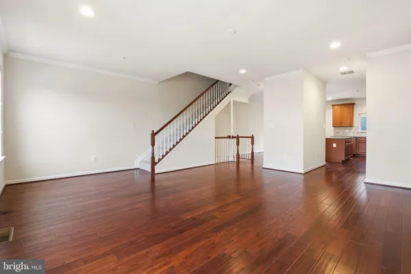 a view of empty room with wooden floor