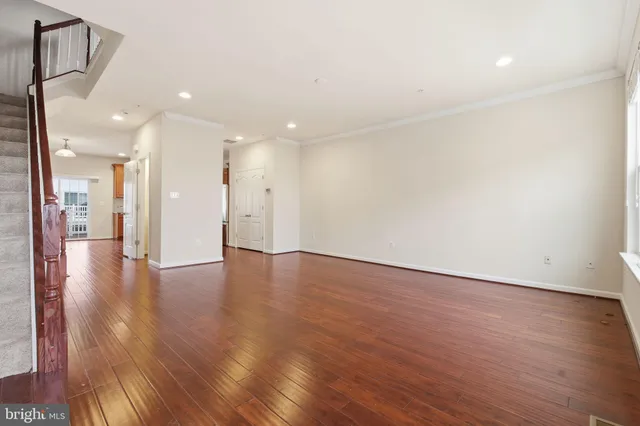a view of an empty room with wooden floor