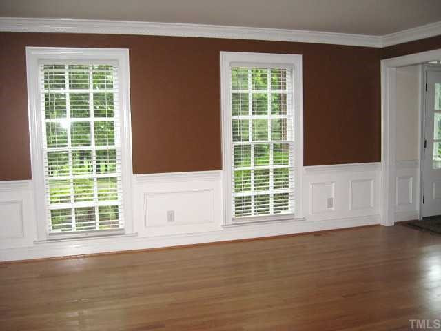 7116 Rainwater Road Raleigh, NC 27615 - Photo 6 of 12 Lovely living room with chair rail/wainscot & tall windows Living Room