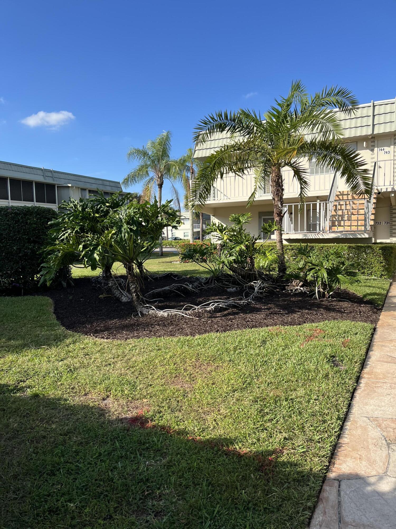 740 Monaco P, Unit P Delray Beach, FL 33446 - Photo 1 of 14 a view of a house with a garden