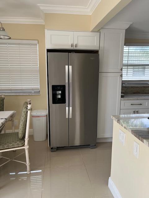 740 Monaco P, Unit P Delray Beach, FL 33446 - Photo 3 of 14 a kitchen with a refrigerator and table